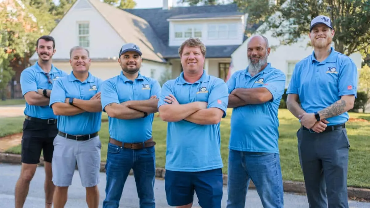 The HW Roofing team standing in front of a Northeast Florida home